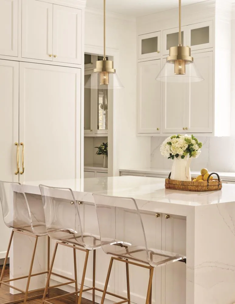 Elegant pendant lighting over a luxurious kitchen island, enhancing the ambiance.
