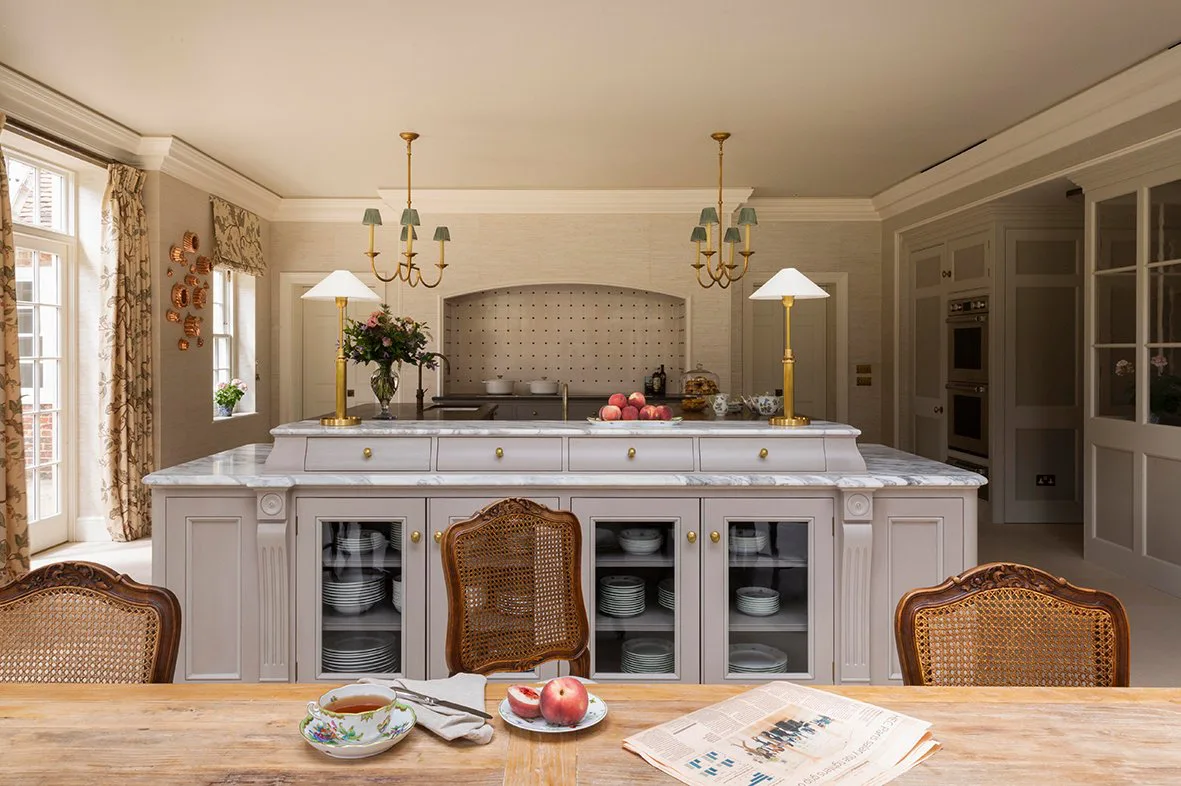 An elegant kitchen showcasing bespoke cabinetry and vibrant luxury countertops.