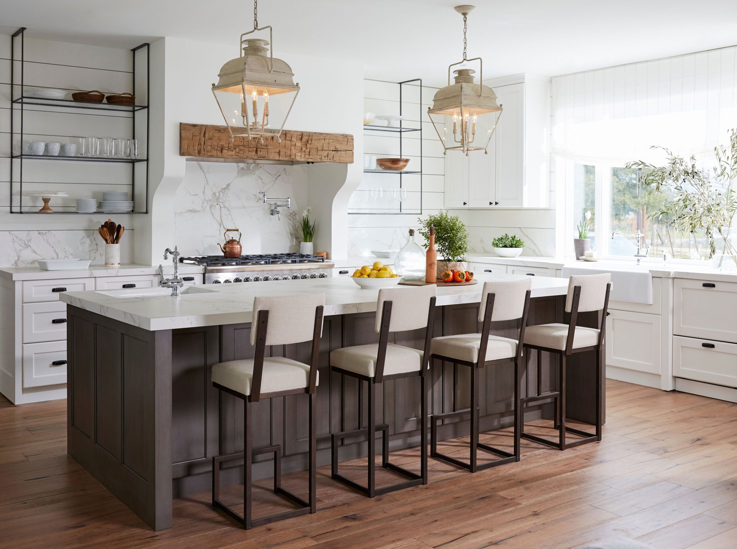 Elegant pendant lighting accentuating the luxury design of a custom kitchen island.
