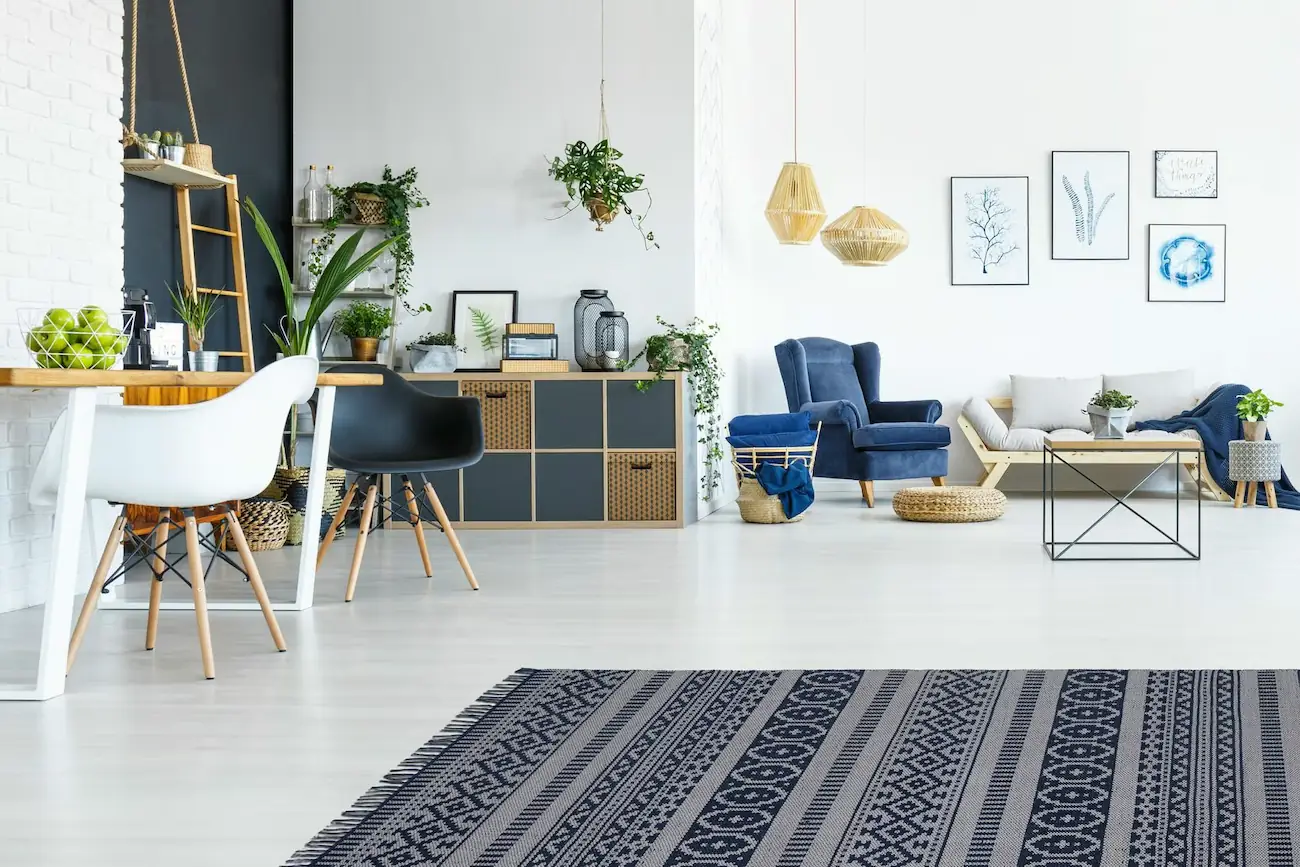 Utilize area rugs to define and separate spaces within an open concept design, enhancing both aesthetics and function.