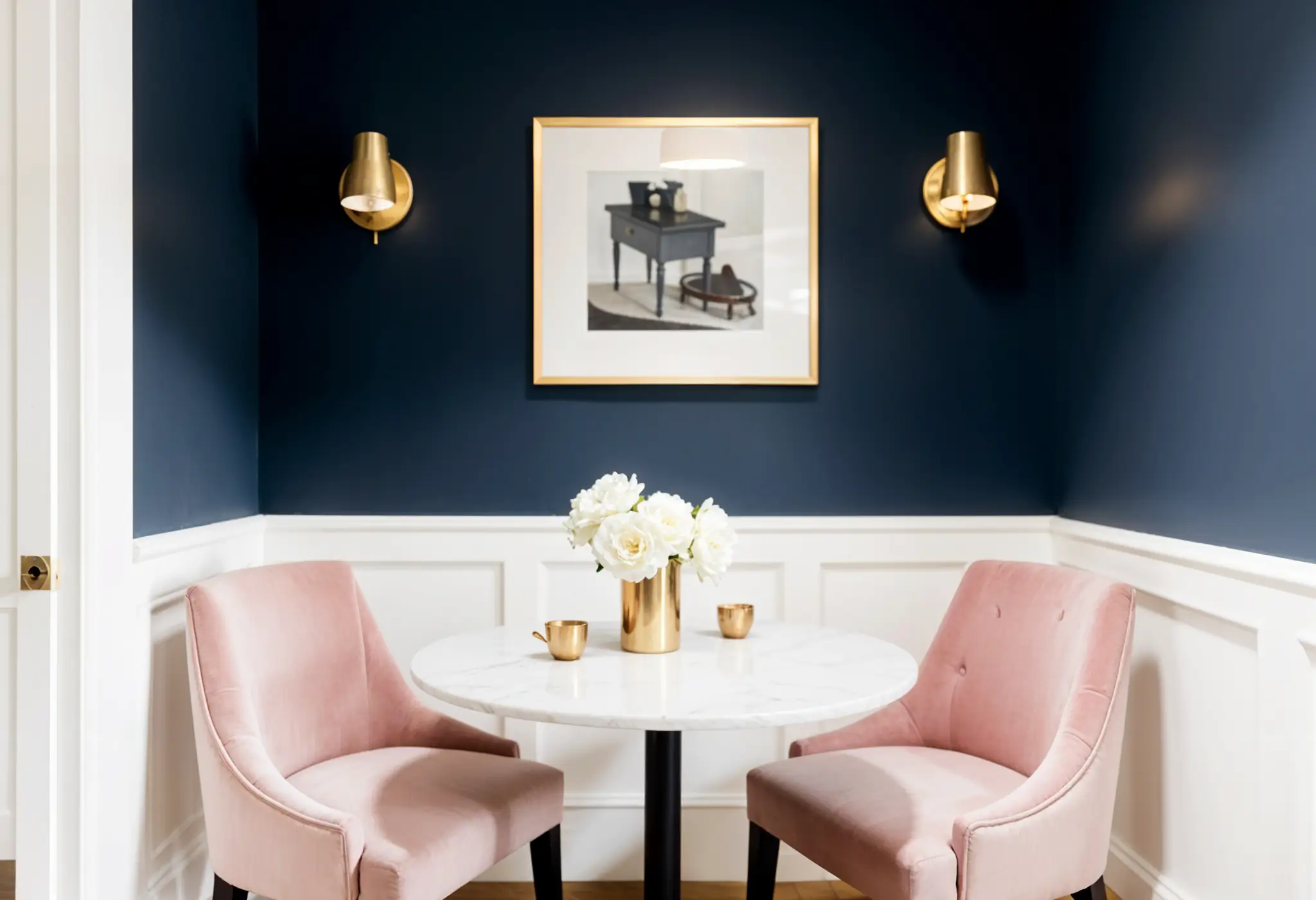 Luxury dining nook with navy walls and dusty rose chairs