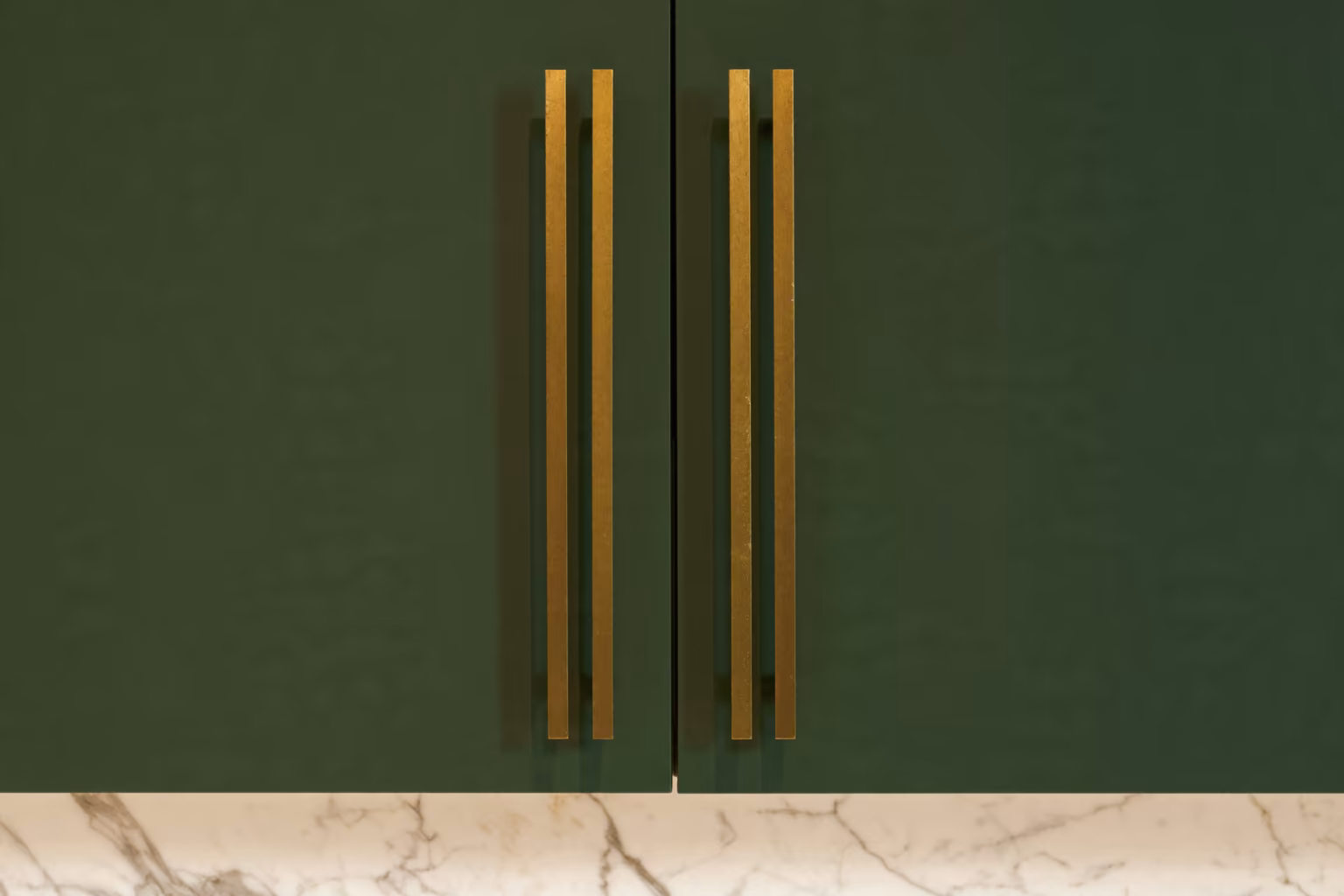 Custom green kitchen cabinets matte lacquer brass hardware NYC millwork